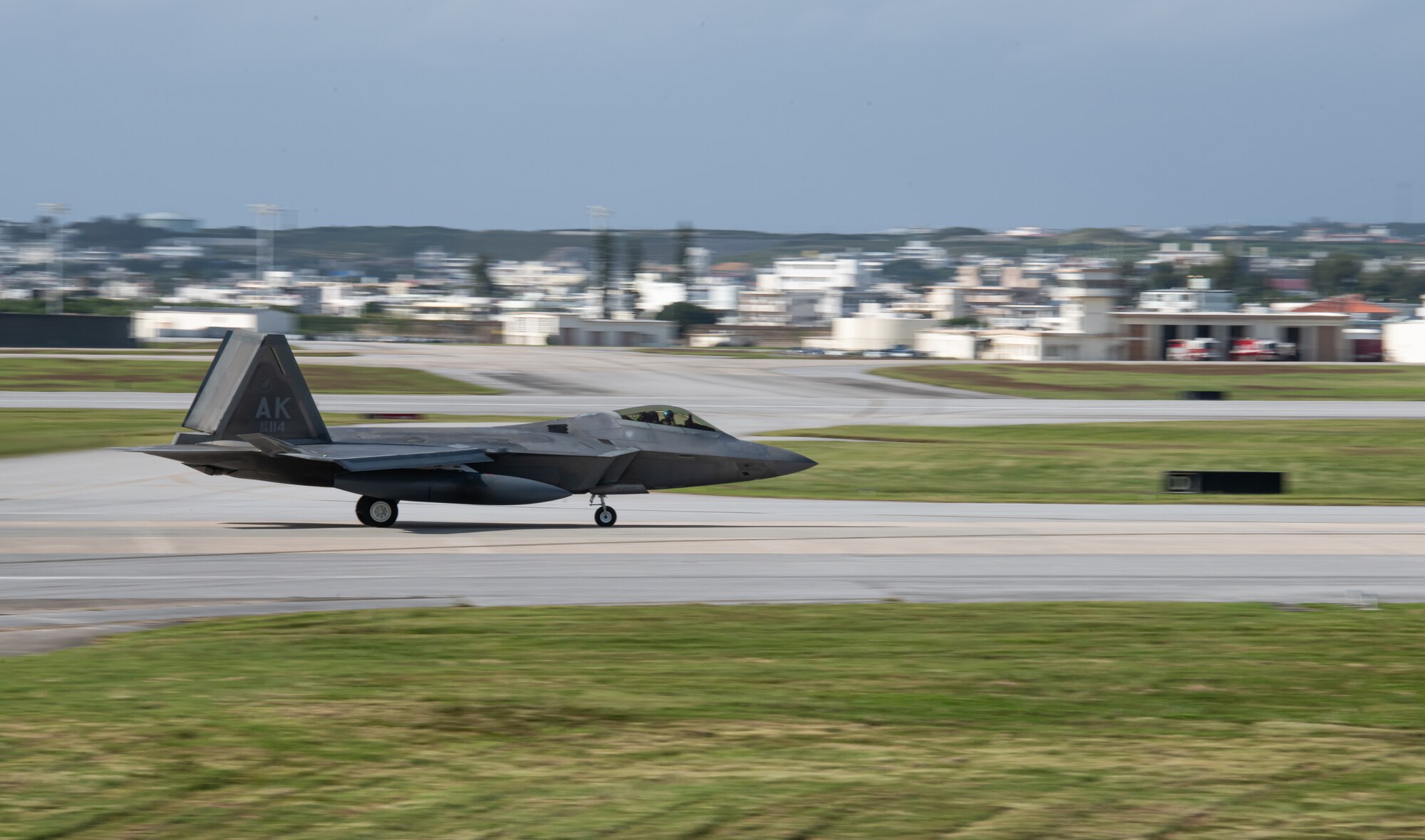 An F-22 Raptor lands on a runway.
