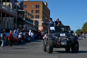 U.S. Air Force Chief Master Sgt. Rebecca Arbona, 17th Training Wing command chief, smiles at the crowd during the All Veterans Council Veterans Day celebration parade, San Angelo, Texas, Nov. 5, 2022. Arbona was the grand marshal for the parade, riding alongside her husband and daughter. (U.S. Air Force photo by Senior Airman Michael Bowman)