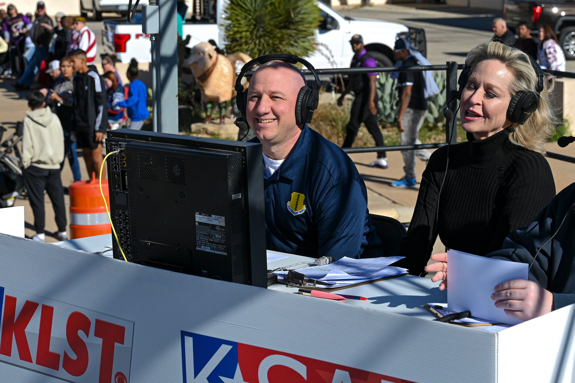 U.S. Air Force Col. Matthew Reilman, 17th Training Wing commander, smiles alongside KLST new anchors during the All Veterans Council Veterans Day celebration parade, San Angelo, Texas, Nov. 5, 2022. Reilman was invited to provide commentary and insight into the operations of Goodfellow Air Force Base during the live television broadcast of the parade. (U.S. Air Force photo by Senior Airman Michael Bowman)
