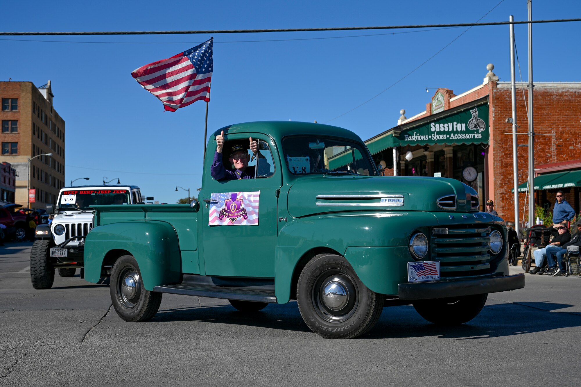 A WWII veteran poses in his truck during the San Angelo All Veterans Council Veterans Day parade downtown, San Angelo, Texas, Nov. 5, 2022. The Parade featured Veterans from every armed conflict dating back to WWII. (U.S. Air Force photo by Senior Airman Michael Bowman)