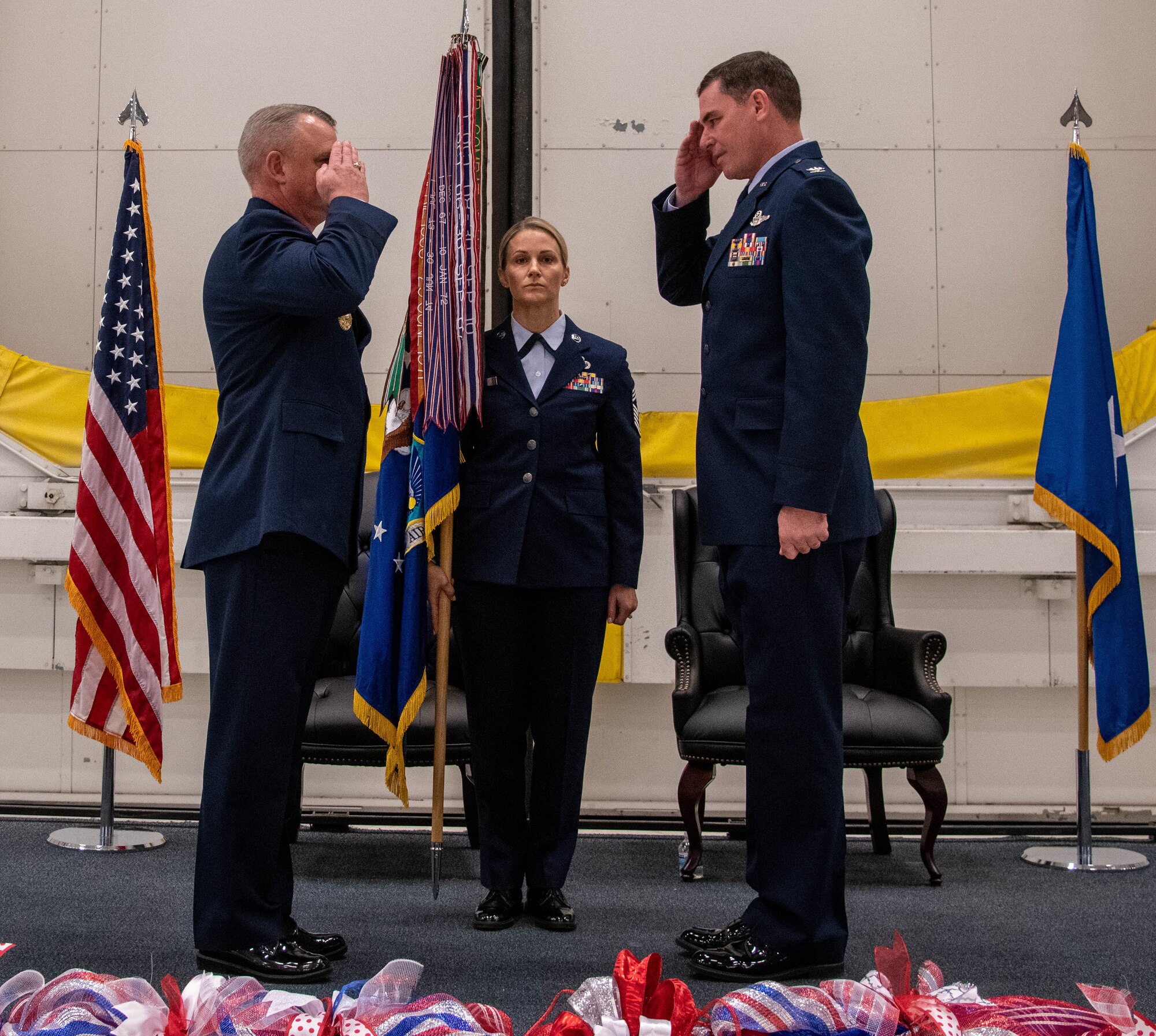 One man saluting another man in Air Force uniform, at a military ceremony.