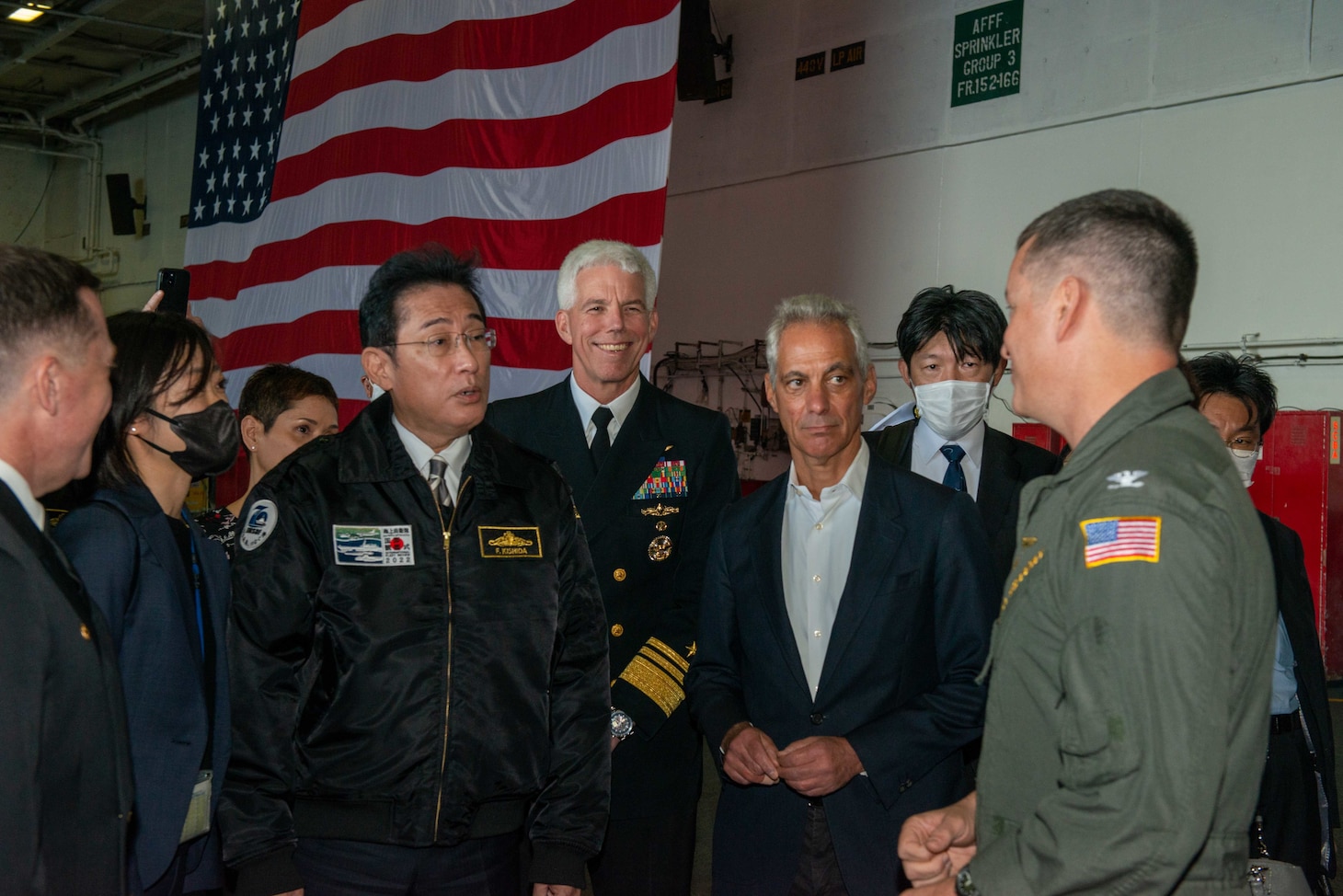SAGAMI WAN (Nov. 6, 2022) Japan Prime Minister Fumio Kishida, left, Honorable Rahm Emanuel, right, U.S. ambassador to Japan, and Vice Adm. Karl Thomas, center, commander, U.S. 7th Fleet, tour the hangar  led by Capt. Michael Sweeny, commander, Carrier Air Wing 5, aboard the U.S. Navy’s only forward-deployed aircraft carrier, USS Ronald Reagan (CVN 76), during the Japan Maritime Self-Defense Force Fleet Review 2022, in the Sagami Wan, Nov. 6. Ronald Reagan, the flagship of Carrier Strike Group 5, provides a combat-ready force that protects and defends the United States, and supports alliances, partnerships and collective maritime interests in the Indo-Pacific region. (U.S. Navy photo by Mass Communication Specialist 2nd Class Michael B. Jarmiolowski)