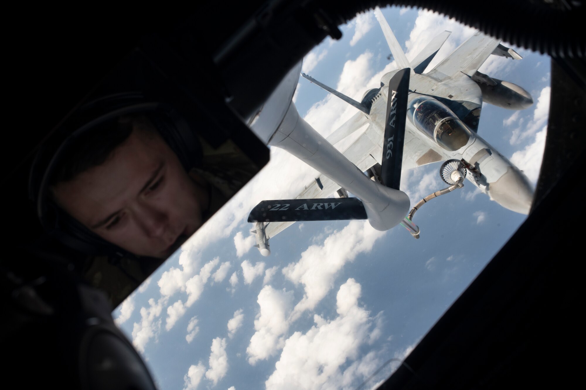 Airman 1st Class Ethan Parker, 909th Air Refueling Squadron boom operator, oversees the refueling of a U.S. Navy F/A-18 Super Hornet during a joint training exercise over the Pacific Ocean, Oct. 24, 2022. Joint training improves interoperability among U.S. forces and enables more effective teamwork during real-world engagements. (U.S. Air Force photo by Senior Airman Jessi Roth)