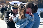 Service member hugs family