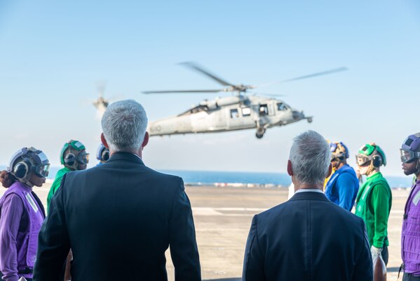 SAGAMI WAN (Nov. 6, 2022) The Honorable Rahm Emanuel, right, U.S. ambassador to Japan, and Vice Adm. Karl Thomas, commander, U.S. 7th Fleet, prepare to greet Adm. Mike Gilday, chief of naval operations, on the flight deck of the U.S. Navy’s only forward-deployed aircraft carrier, USS Ronald Reagan (CVN 76), prior to a ship tour as part of the Japan Maritime Self-Defense Force Fleet Review 2022 in the Sagami Wan, Nov. 6. Ronald Reagan, the flagship of Carrier Strike Group 5, provides a combat-ready force that protects and defends the United States, and supports alliances, partnerships and collective maritime interests in the Indo-Pacific region. (U.S. Navy photo by Mass Communication Specialist 3rd Class Gray Gibson)