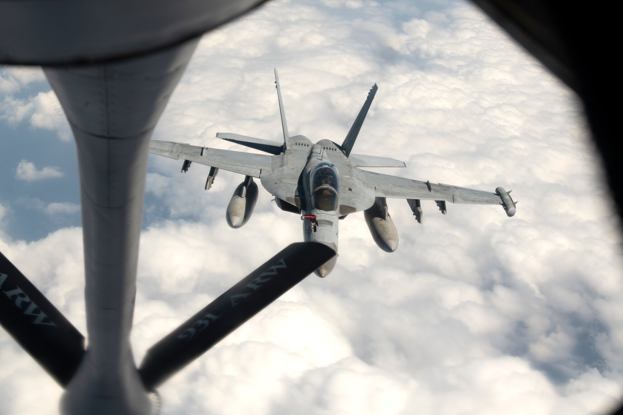A U.S. Navy F/A-18 Super Hornet approaches a KC-135 Stratotanker assigned to the 909th Air Refueling Squadron during a joint training exercise over the Pacific Ocean, Oct. 24, 2022. Joint training strengthens partnerships and enhances capabilities, allowing the U.S. to maintain air supremacy and ensure a free and open Indo-Pacific. (U.S. Air Force photo by Senior Airman Jessi Roth)