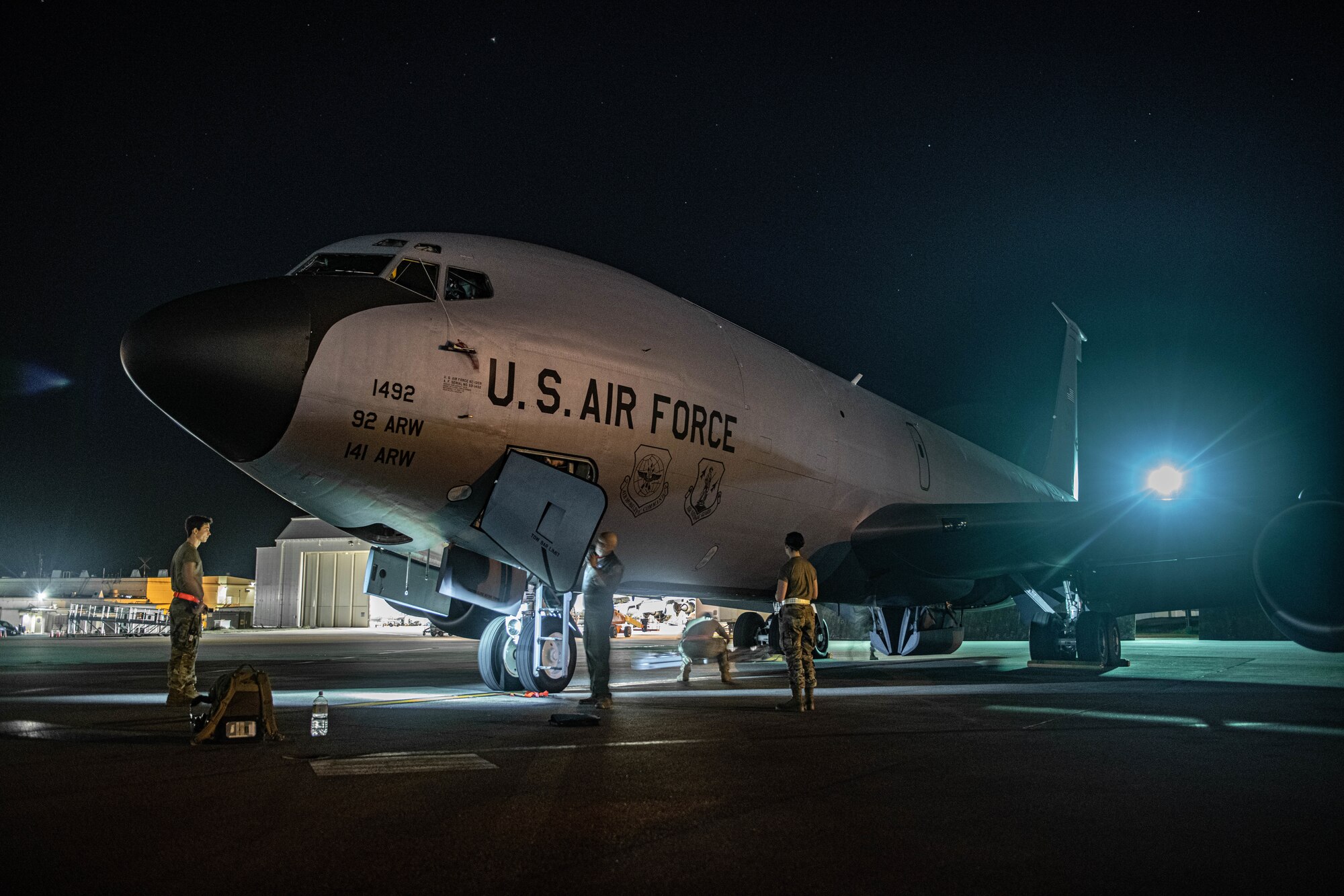 Airmen from the 909th Air Refueling Squadron perform pre-flight checks on a KC-135 Stratotanker before a refueling mission at Kadena Air Base, Japan, Oct. 27, 2022. Kadena Air Base is the hub of airpower in the Pacific, and home to the 18th Wing and a variety of associate units to form a world-class combat team ready to ensure peace and stability across the Indo-Pacific. (U.S. Air Force photo by Airman Alexis Redin)