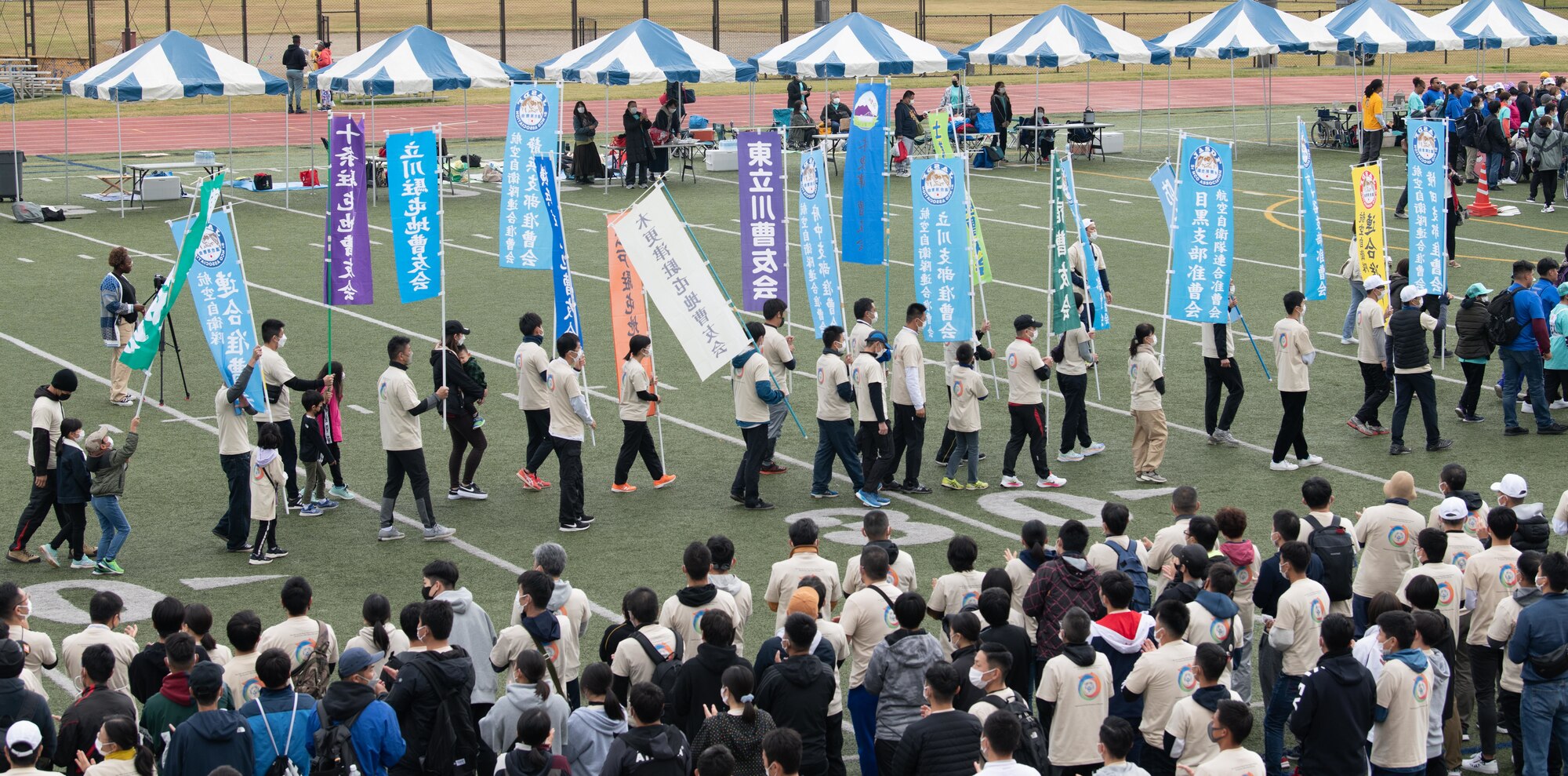 People holding flags surrounded by a crowd.