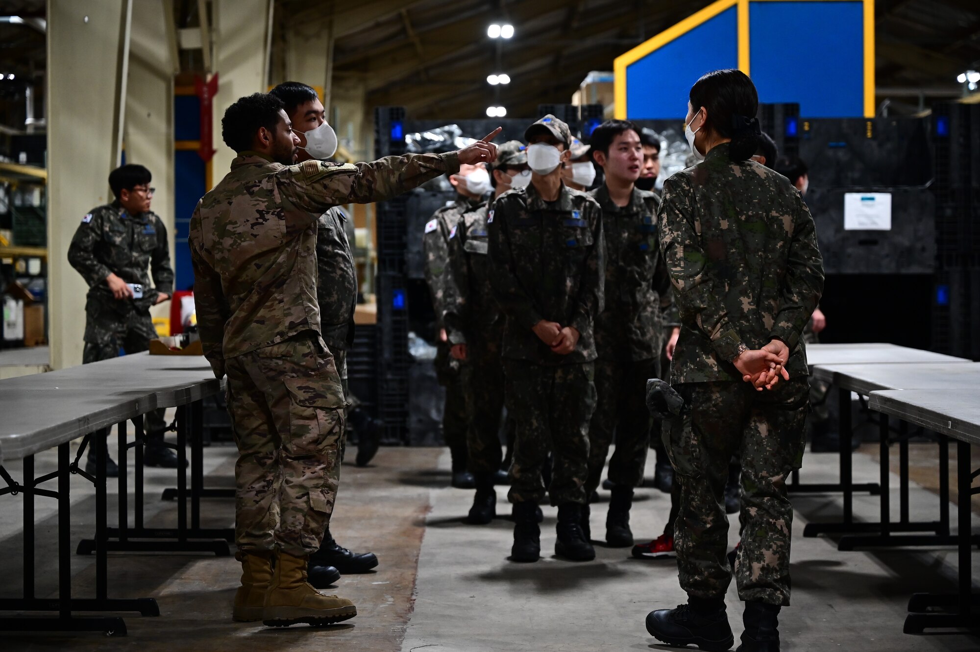 Staff Sgt. Frederick Martin, 8th Logistics Readiness Squadron individual protective equipment supervisor, provides a briefing about an 8th LRS warehouse to Republic of Korea Air Force logistics personnel during a combined immersion at Kunsan Air Base, Republic of Korea, Oct. 27, 2022. During the immersion, participants pointed out unique resources that enable mission capabilities. (U.S. Air Force photo by Staff Sgt. Isaiah J. Soliz)