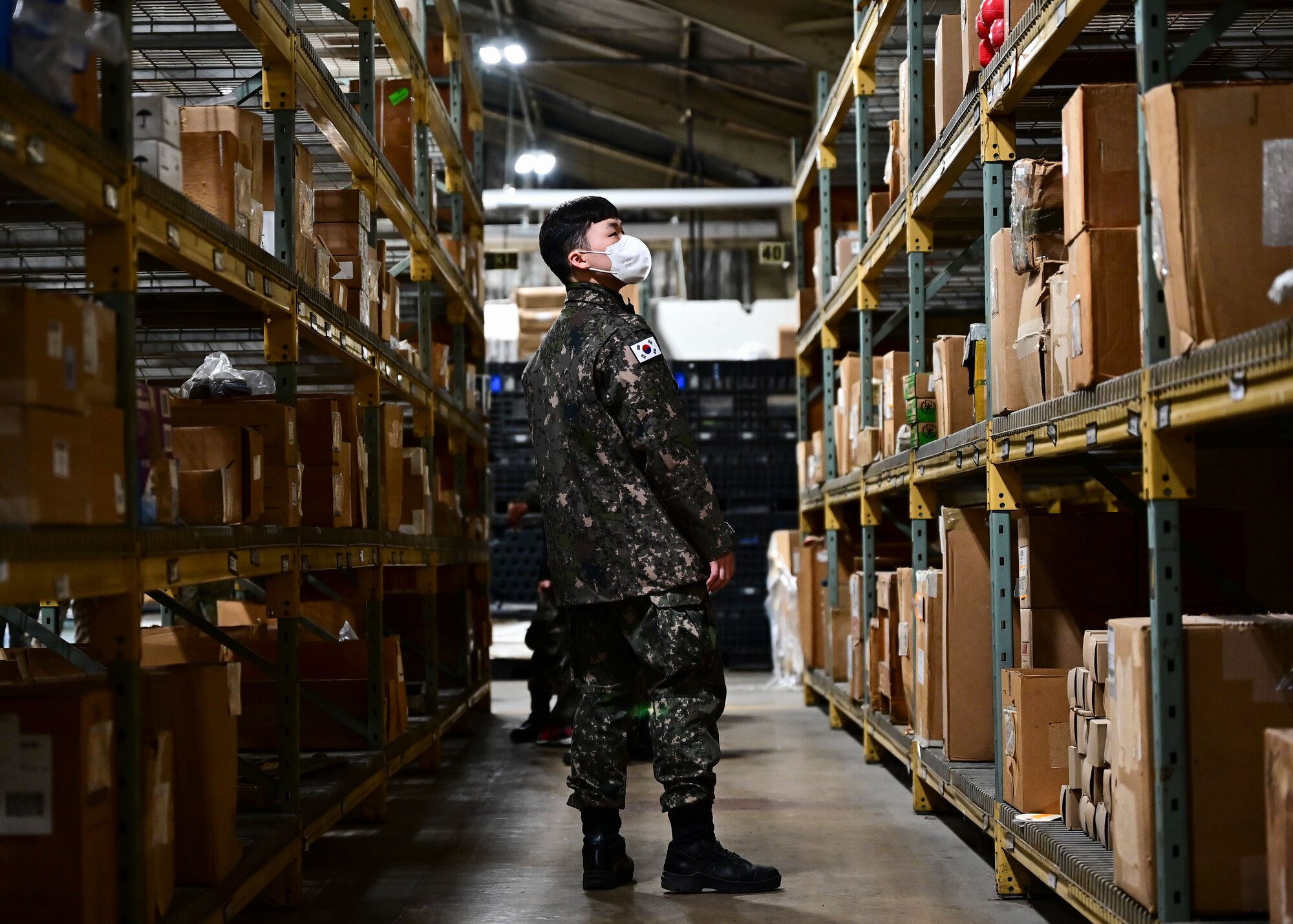 A Republic of Korea Air Force member examines an 8th Logistics Readiness Squadron warehouse during a combined immersion at Kunsan Air Base, Republic of Korea, Oct. 27, 2022. The combined immersion allowed the partner forces to learn about their counterpart’s mission set, tour facilities and ask questions. (U.S. Air Force photo by Staff Sgt. Isaiah J. Soliz)