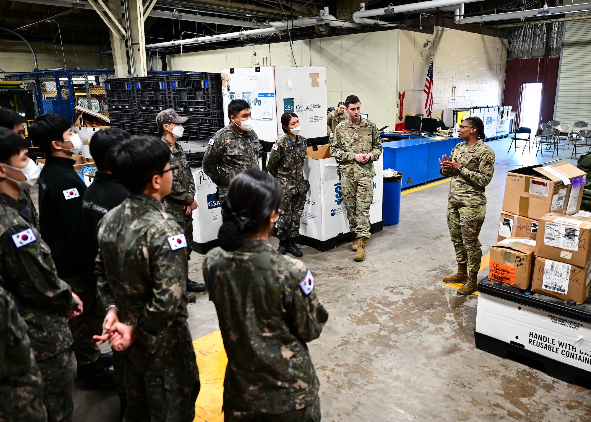 Senior Master Sgt. Kellie Babino, 8th Logistics Readiness Squadron materiel management flight chief, speaks with Republic of Korea Air Force personnel during a combined ROKAF-USAF immersion at Kunsan Air Base, Republic of Korea, Oct. 27, 2022. Each partner force had the opportunity  to strengthen their partnership and advance mission capabilities by learning from one another.  (U.S. Air Force photo by Staff Sgt. Isaiah J. Soliz)