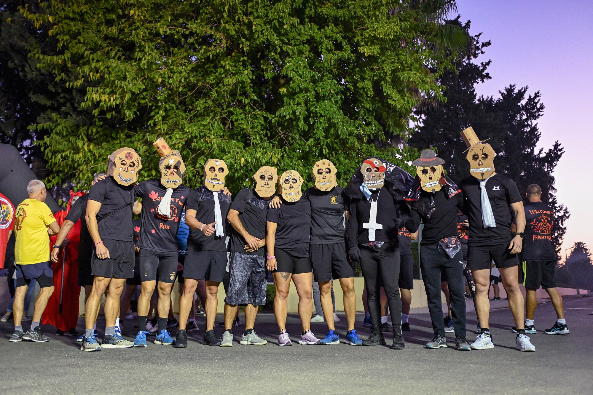 Military members assigned to Incirlik Air Base, Turkey, pose for a photo before a 5k costume run during the Trunk or Treat event at Incirlik AB, Oct. 29, 2022.
