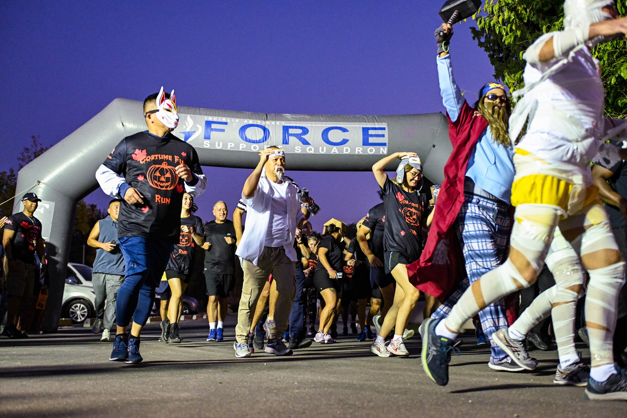 Military members assigned to Incirlik Air Base, Turkey, run during a 5k costume run during the Trunk or Treat event at Incirlik AB, Oct. 29, 2022.