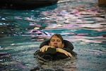 Maj. Addison Harding, an F-16 pilot assigned to the 114th Fighter Wing in Sioux Falls, South Dakota, swims during a SERE refresher course at the Midco Aquatic Center in Sioux Falls Sept. 30, 2022.