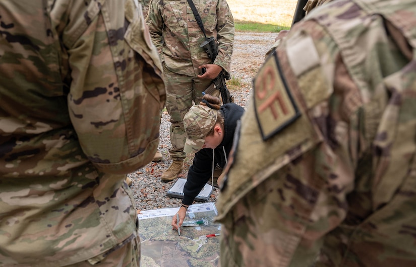 U.S. Air Force Senior Airman Cameron Zihlam, 633d Security Forces Squadron pass and registration clerk, maps out a route during an exercise at Joint Base Langley-Eustis, Virginia, Nov. 1, 2022.