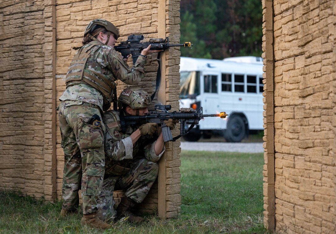 U.S. Air Force Airman 1st Class Rebecca Carolan, entry controller, and Senior Airman Miguel Tapia, response force leader, both with the 633d Security Forces Squadron fire blank rounds at a simulated enemy force at Joint Base Langley-Eustis, Virginia, Nov. 1, 2022.