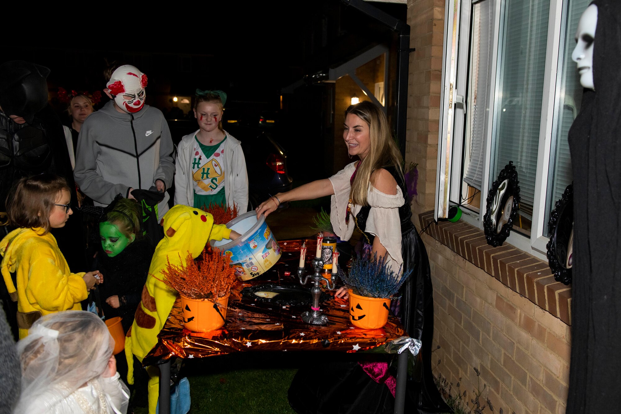 Hundreds of children dressed as ghosts, ghouls and goblins visit residences near RAF Croughton to celebrate Halloween with American personnel Oct. 31, 2022. Pumpkin patrol volunteers from Croughton worked together with the Ministry of Defence Police, Cherwell District Council and Thames Valley Police to help promote a safe and good time. Local American and multinational military and civilians participated in creating a special night for the local community near Croughton. (U.S. Air Force photo by Senior Airman Jennifer Zima)