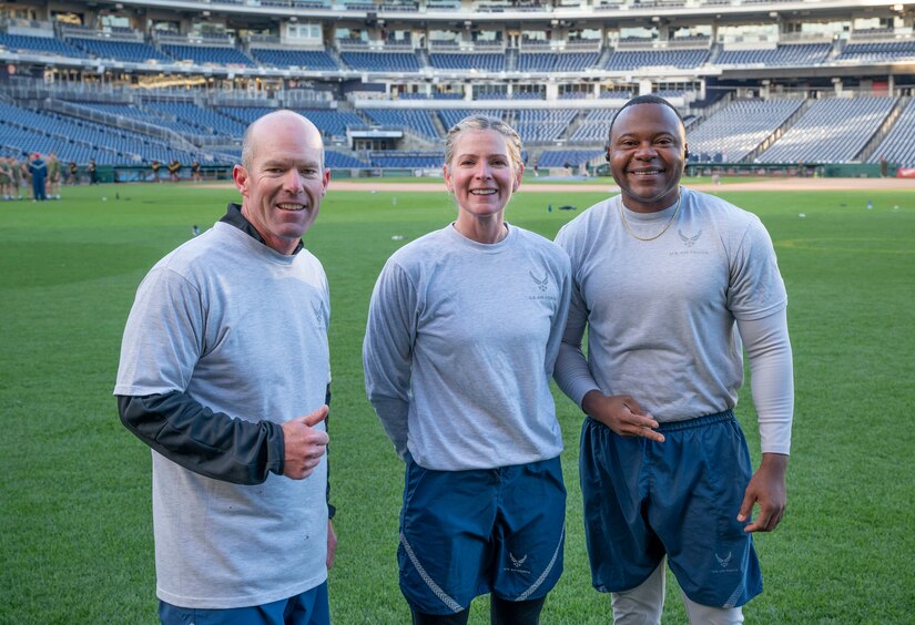 Vice commander U.S. Air Force Col. Ryan Zeitler, commander Col. Catherine “Cat” Logan and command chief Chief Master Sgt. Clifford Lawton, all assigned to Joint Base Anacostia-Bolling and the 11th Wing, pose for a photo between stations at a circuit workout hosted by the Washington Nationals baseball team on Oct. 28, 2022, at Nationals Park in Washington, D.C. JBAB strives to engage in events with the community to create partnerships throughout the National Capital Region. (U.S. Air Force photo by Jason Treffry)