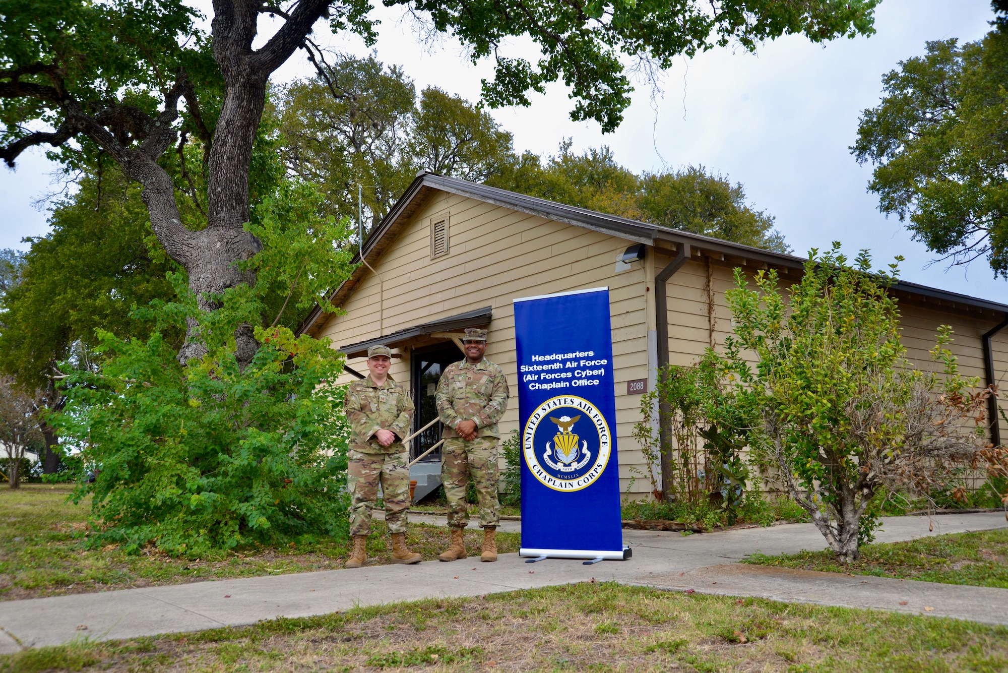 Two Airmen in front of a building.