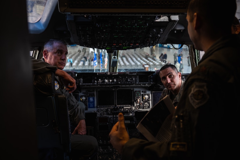 U.S. Air Force Gen. Mike Minihan, Air Mobility Command commander, and Chief Master Sgt. Brian Kruzelnick, AMC command chief, receive a C-17 Globemaster III brief from Maj. Dan Jones, 305th Air Mobility Wing pilot, at Joint Base McGuire-Dix-Lakehurst, N.J., Nov. 1, 2022.