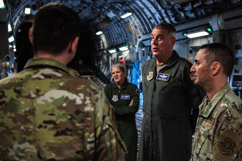 U.S. Air Force Gen. Mike Minihan, Air Mobility Command commander, and Chief Master Sgt. Brian Kruzelnick, AMC command chief, receive a C-17 Globemaster III Maintenance and Tactical Employment brief from an Airman assigned to the 305th Air Mobility Wing at Joint Base McGuire-Dix-Lakehurst, N.J., Nov. 1, 2022.