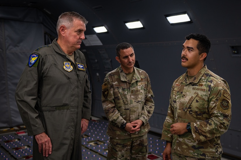 U.S. Air Force Gen. Mike Minihan, Air Mobility Command commander, and Chief Master Sgt. Brian Kruzelnick, AMC command chief, receive a flying crew chief brief from Staff Sgt. Gavriel Torres, 305th Air Mobility Wing flying crew chief, aboard a KC-46A Pegasus at Joint Base McGuire-Dix-Lakehurst, N.J., Nov. 1, 2022.
