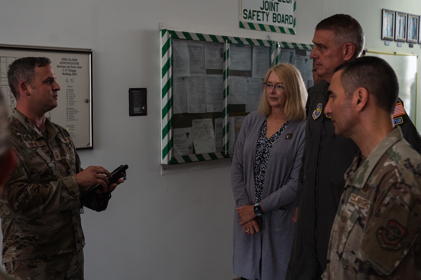 U.S. Air Force Gen. Mike Minihan, Air Mobility Command commander, his wife, Ashley Minihan, and Chief Master Sgt. Brian Kruzelnick, AMC command chief, receive an Integrated Multi-purpose Port Operations System and Execution brief from Master Sgt. Sean Cyphert, 305th Aerial Port Squadron load planning section chief, at Joint Base McGuire-Dix-Lakehurst, N.J., Nov. 1, 2022.