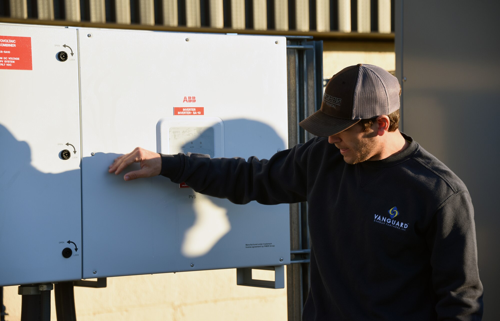A class instructor demonstrates the use of an electrical inverter.