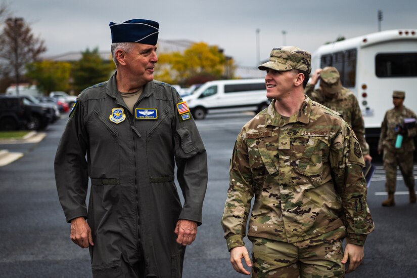 U.S. Air Force Gen. Mike Minihan, Air Mobility Command commander, and Senior Airman Austin Sondergard, 305th Air Mobility Wing crew chief, discuss Sondergard’s recovery from brain surgery at Joint Base McGuire-Dix-Lakehurst, N.J., Nov. 1, 2022.