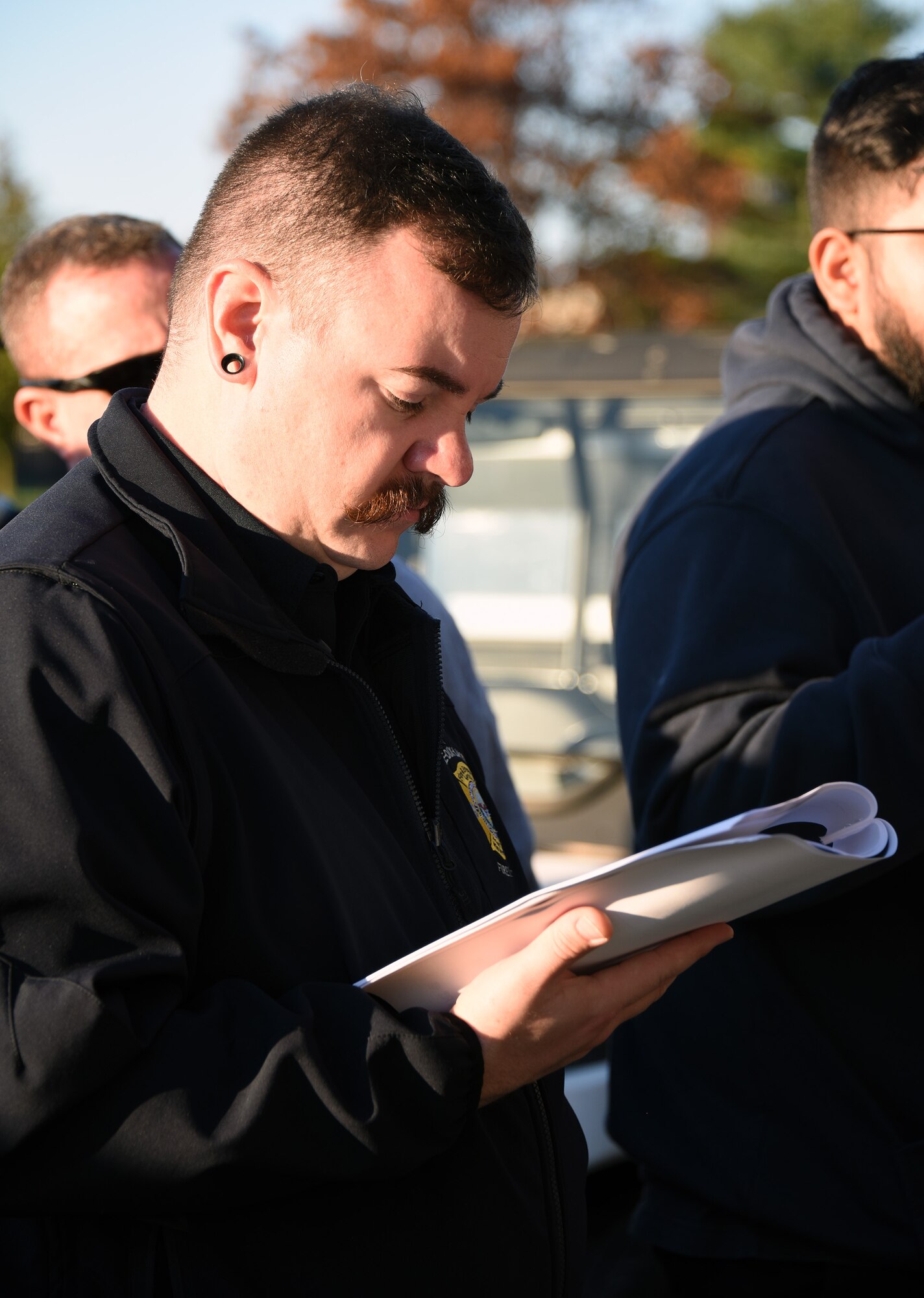 A firefighter reads a training manual about safe system operations.