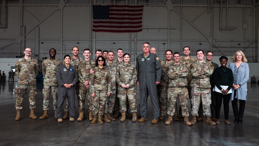 U.S. Air Force Gen. Mike Minihan, Air Mobility Command commander, and Chief Master Sgt. Brian Kruzelnick, AMC command chief, pose for a photo with 305th Air Mobility Wing Airmen designated as star performers at Joint Base McGuire-Dix-Lakehurst, N.J., Nov. 1, 2022.