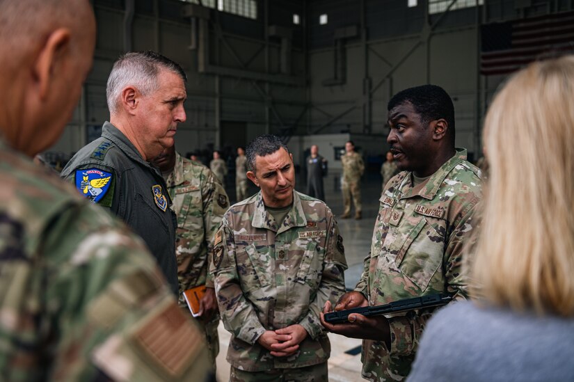 U.S. Air Force Gen. Mike Minihan, Air Mobility Command commander, and Chief Master Sgt. Brian Kruzelnick, AMC command chief, receive a Flightline of the Future brief from Tech. Sgt. Gerry Donald, 305th Maintenance Group operations supervisor, at Joint Base McGuire-Dix-Lakehurst, N.J., Nov. 1, 2022.