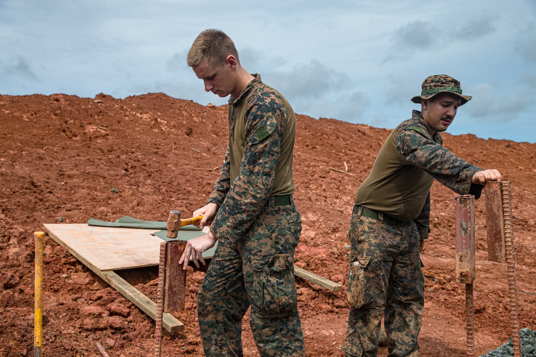 U.S. Marine Corps Lance Cpl. Shane Cooke, left, an engineer equipment operator, and Lance Cpl. Ryan Yazzie, a combat engineer, both with Task Force Koa Moana 22, I Marine Expeditionary Force, set up targets during construction of the Joint Range Complex in Ngatpang, Republic of Palau, July 5, 2022. The Joint Range Complex will provide the U.S. military and Palauan law enforcement agencies a place to sharpen their skills and improve marksmanship capabilities, strengthening readiness and interoperability in support of U.S. Indo-Pacific Command’s strategic and operational objectives.