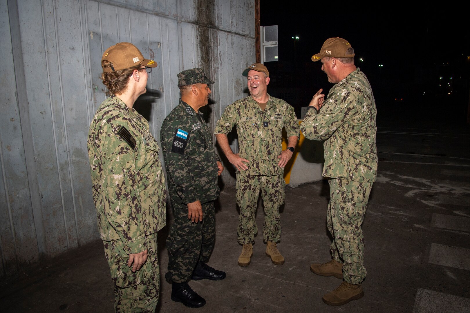Capt. Kathryn S. Elliott, from left, commanding officer of the Medical Treatment Facility aboard the hospital ship USNS Comfort (T-AH 20), Honduran navy Capt. Juan De Jesus, deputy commodore for Amphibious Squadron (PHIBRON) 4, Rear Adm. Douglas W. Sasse, III, Reserve Vice Commander, U.S. 4th Fleet, and Capt. Bryan Carmichael, commodore of PHIBRON 4, meet after the ship arrived for Continuing Promise 22 in Puerto Cortes, Honduras, Nov. 3, 2022. Comfort is deployed to U.S. 4th Fleet in support of CP22, a humanitarian assistance and goodwill mission conducting direct medical care, expeditionary veterinary care, and subject matter expert exchanges with five partner nations in the Caribbean, Central and South America