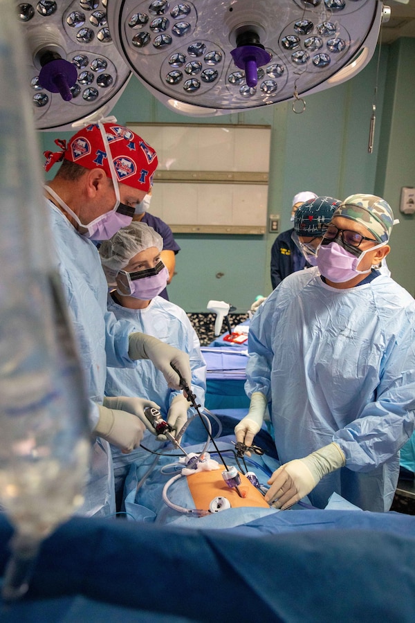 Cmdr. Tim Donahue, left, assigned to the hospital ship USNS Comfort (T-AH 20), leads a surgery, at the ship during Continuing Promise 2022, Nov. 05, 2022.