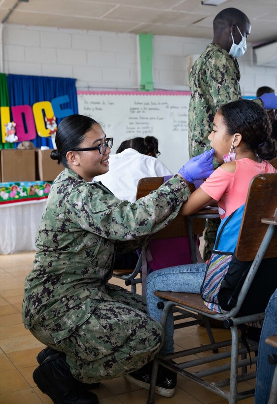 Hospital Corpsman 2nd Class Jinuel Jehlen, a dental hygienist from Bulacan, Philippines, assigned to the hospital ship USNS Comfort (T-AH 20), applies fluoride to students at Escuela San Martin Porres in Puerto Cortes, Honduras, Nov. 4, 2022.