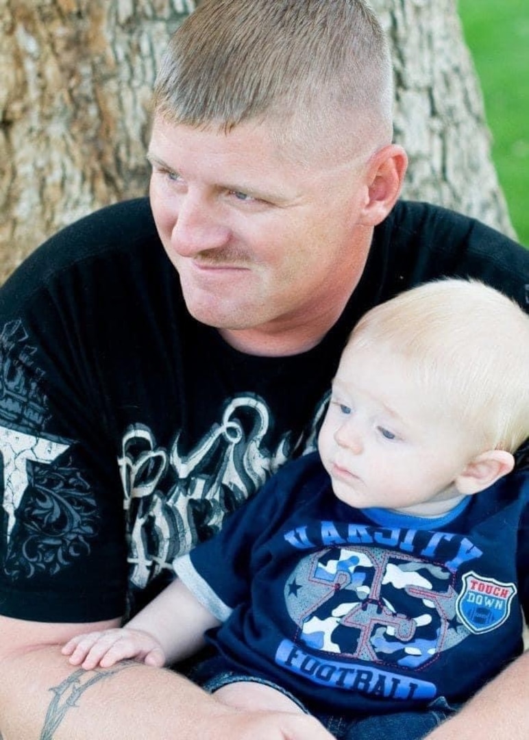 Pictured here is late Marine Corps Sgt. Christopher Jacobs, previously attached to Delta Company, 3rd Assault Amphibian Battalion in Twentynine Palms, California, and his son Christian Jacobs, approximately six months old. Christopher was killed in a training accident in 2011, two months later.