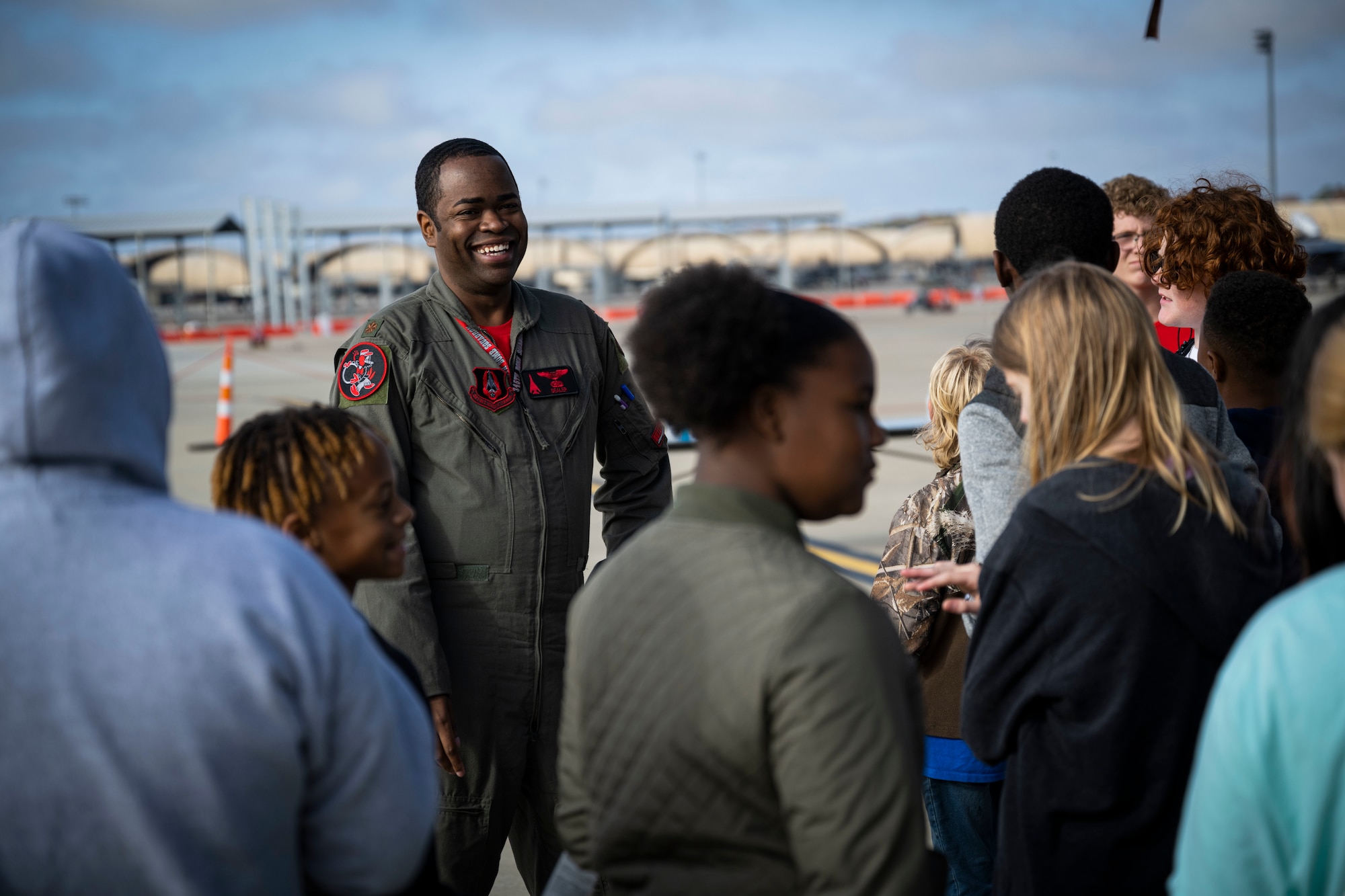 Maj. Ellis Clagget, 345th Bomb Squadron, Dyess Air Force Base, Texas, weapons systems officer, speaks with students during Strive 4th: A Project Tuskegee and aviation inspiration mentorship initiative at Seymour Johnson AFB, North Carolina, Nov. 4, 2022. Strive 4th is a partnership between the 4th Fighter Wing and AFGSC to introduce Wayne County students and North Carolina Air Force ROTC detachments to aviation and STEM.