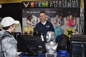 Mark Erickson, Hill's STEM Outreach Program coordinator, speaks to a student at the Northern Utah STEM Expo Nov. 7. The community event was an opportunity for students to engage with multiple STEM-driven businesses and higher-education institutions so they will have the necessary information and background to make informed career path decisions.