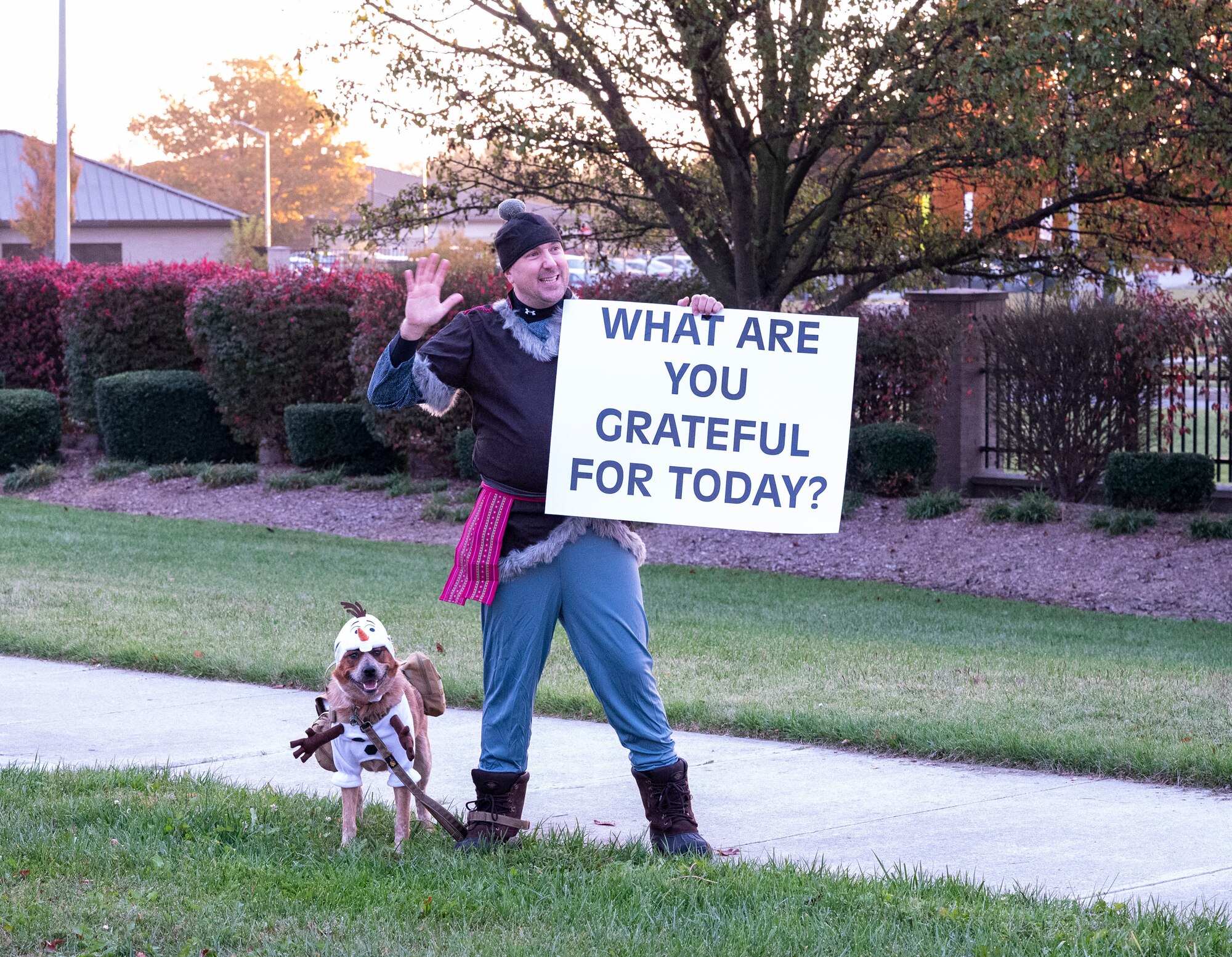 Master Sgt. Lance Tressler, 436th Airlift Wing noncommissioned officer in charge of religious affairs, along with his service dog, Izzy, greet personnel headed towards the main gate at Dover Air Force Base, Delaware, Oct. 31, 2022. Tressler, a native of Loganton, Pennsylvania predicted Dover AFB’s first snowfall of a quarter-inch or greater will occur Jan. 11, 2023. (U.S. Air Force photo by Airman 1st Class Amanda Jett)