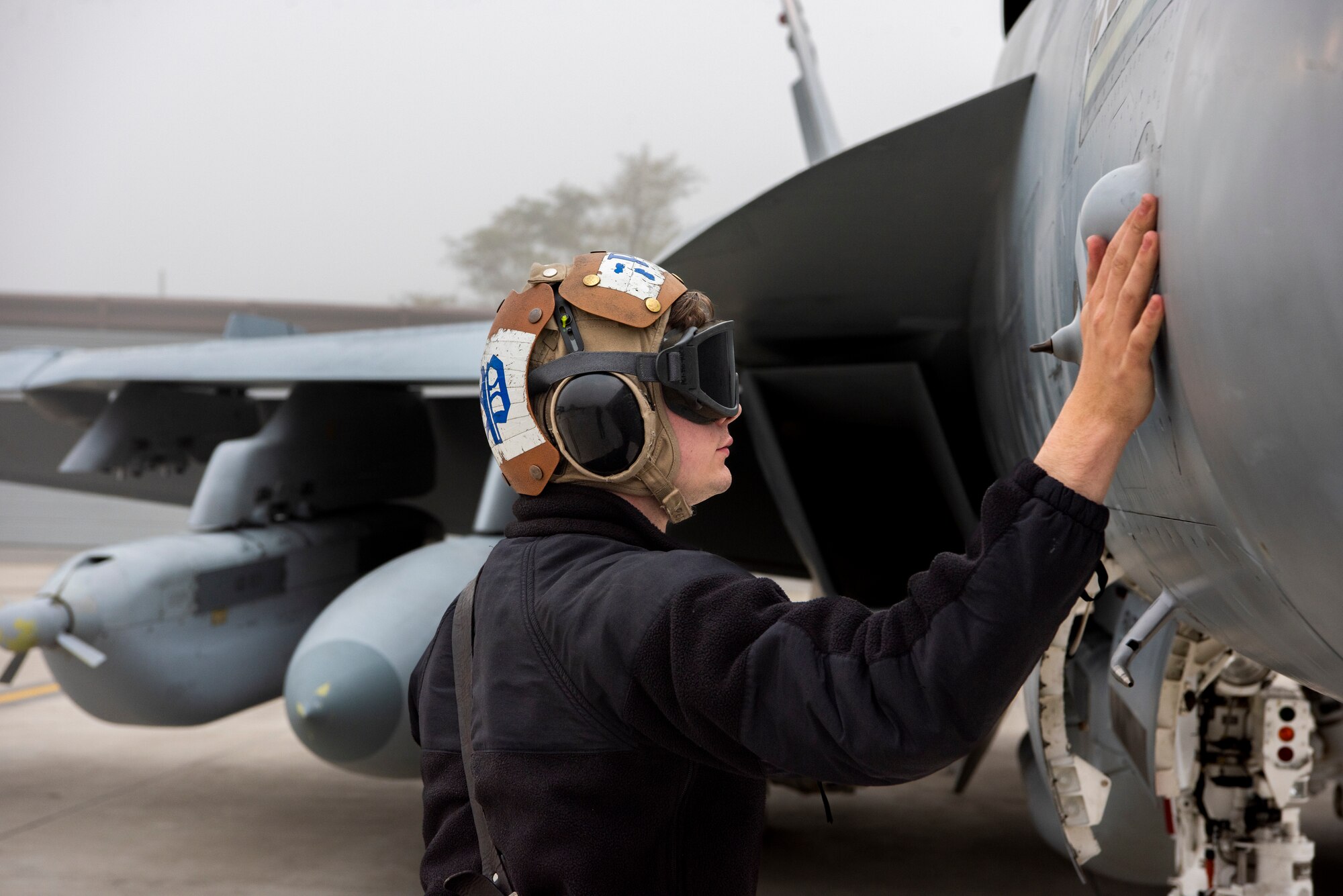 U.S. Navy Petty Officer 3rd Class Robert Bolton, aviation electronics technician assigned to Electronic Attack Squadron (VAQ) 131 at Naval Air Station Whidbey Island, Washington, inspects an EA-18G Growler during Vigilant Storm 23 at Osan Air Base, Republic of Korea, Nov. 1, 2022.