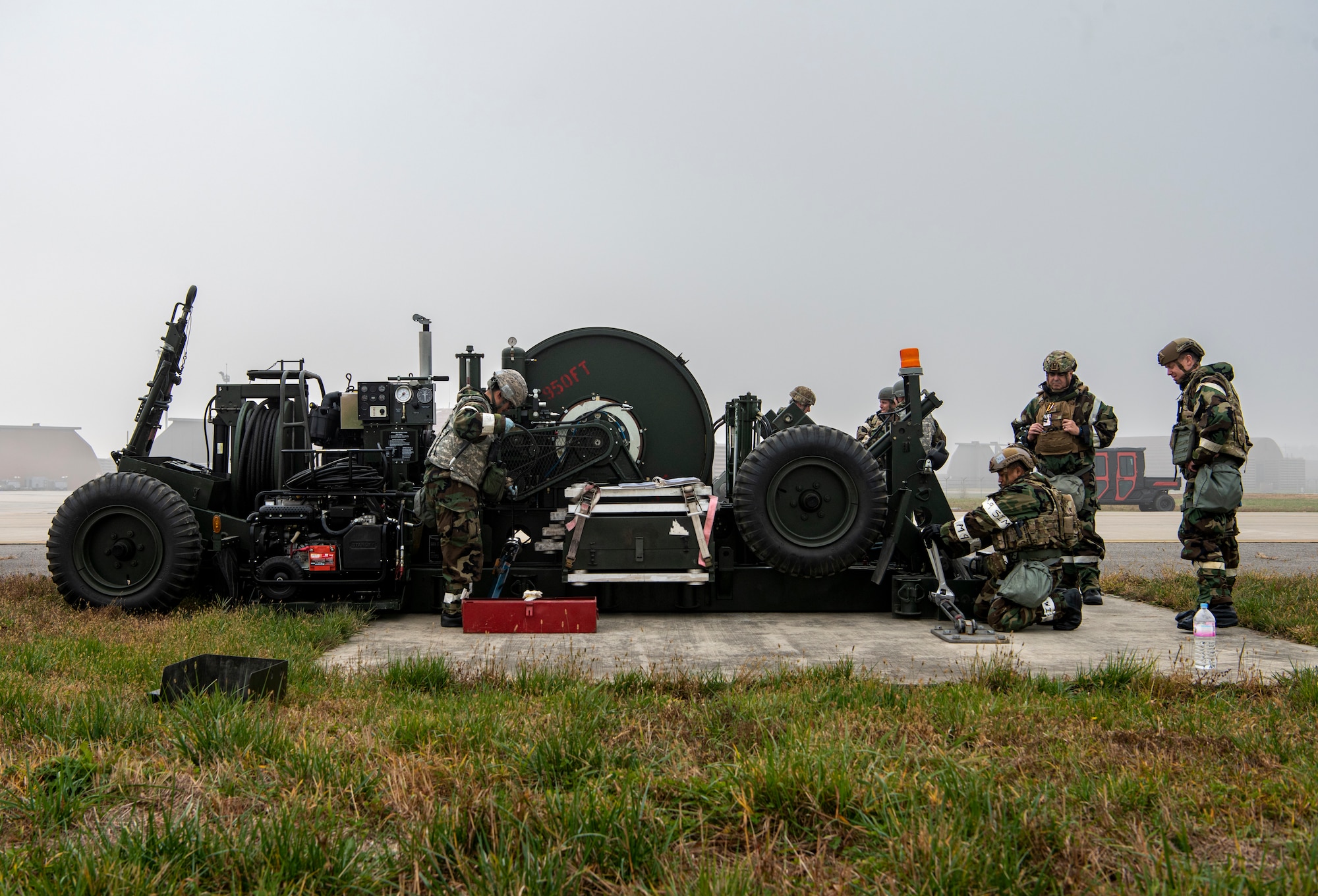 U.S. Air Force 51st Civil Engineer Squadron electrical power production Airmen measure cable distance for the Mobile Aircraft Arresting System (MAAS) during Vigilant Storm 23 at Osan Air Base, Republic of Korea, Nov. 1, 2022.