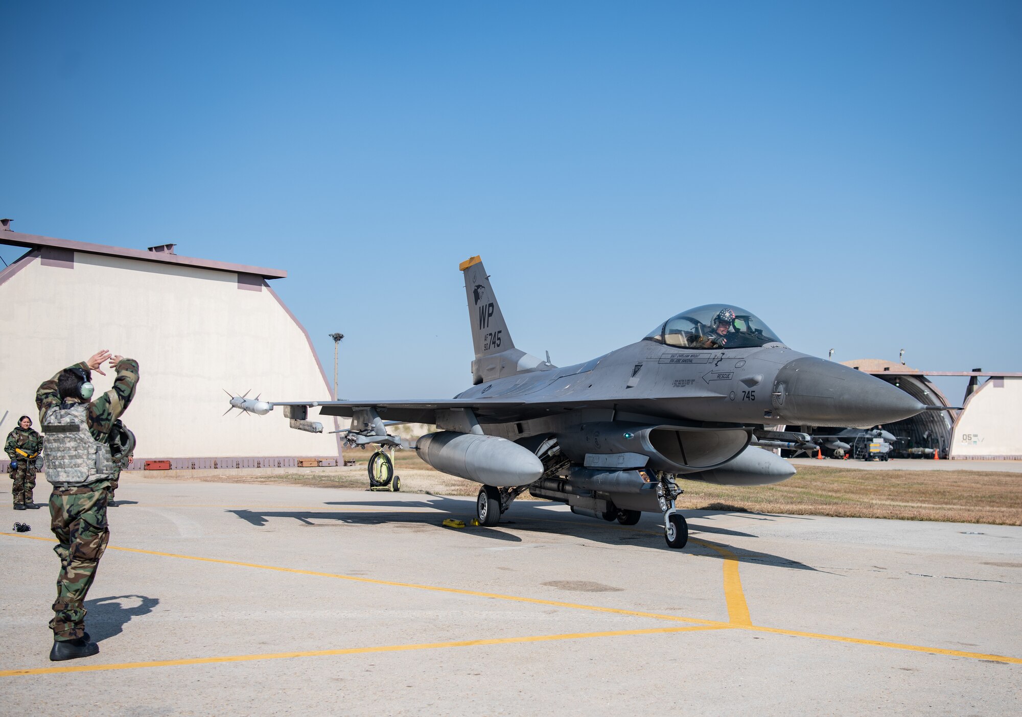 U.S. Air Force Airman 1st Class Alejandro Rafuls-Maciro, 80th Fighter Generation Squadron crew chief, motions to an F-16 Fighting Falcon to turn engines off at Kunsan Air Base, Republic of Korea, Nov. 2, 2022.