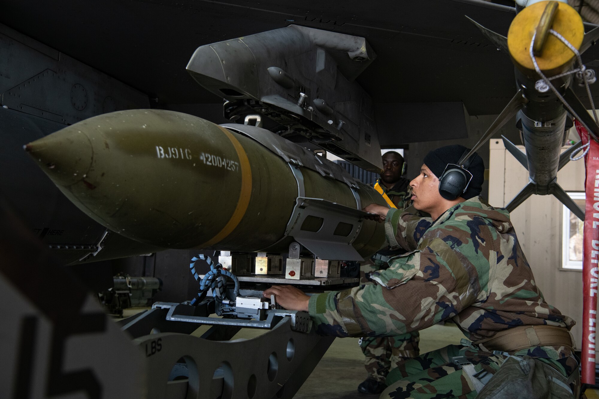U.S. Air Force Staff Sgt. Tristan Bowen, 80th Fighter Generation Squadron weapons load crewmember, assists in loading a guided-bomb unit-31 (GBU-31) at Kunsan Air Base, Republic of Korea, Nov. 2, 2022.