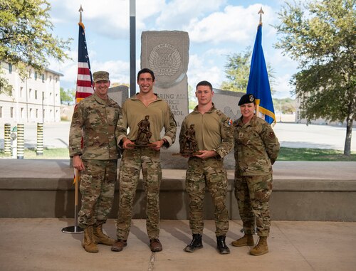 The winners of the best air support operations squadron, 1st Lt. John Dabagian and Senior Airman Elijah Rutter of the 20th ASOS, pose for a photo with Col. Nathan Colunga (far left), Special Warfare Training Wing commander, and Command Chief Master Sgt. Tessa Fontaine (far right), SWTW command chief (U.S. Air Force photo by Katherine Spessa).