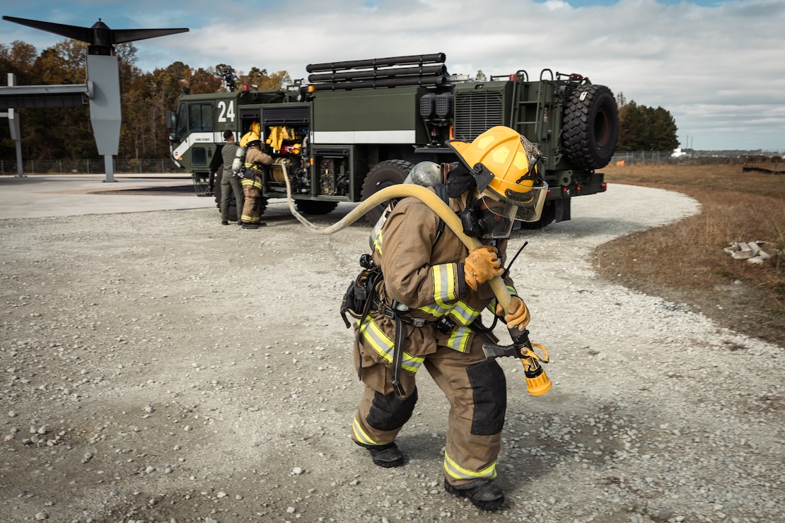 Aircraft rescue and firefighting Marines with Headquarters and Headquarters Squadron, Marine Corps Air Station New River, stage gear before a downed aircraft training on a MV-22B Osprey Simulator on MCAS New River in Jacksonville, North Carolina, Oct. 31, 2022. Aircraft rescue and firefighter Marines train in fire suppression, rescue and emergency response, in order to respond efficiently to emergency situations involving aircraft. MCAS New River provides aviation support, force protection, infrastructure, and community services to promote the readiness, sustainment and quality of life for II Marine Expeditionary Force and other military forces, tenant commands, personnel and their families.