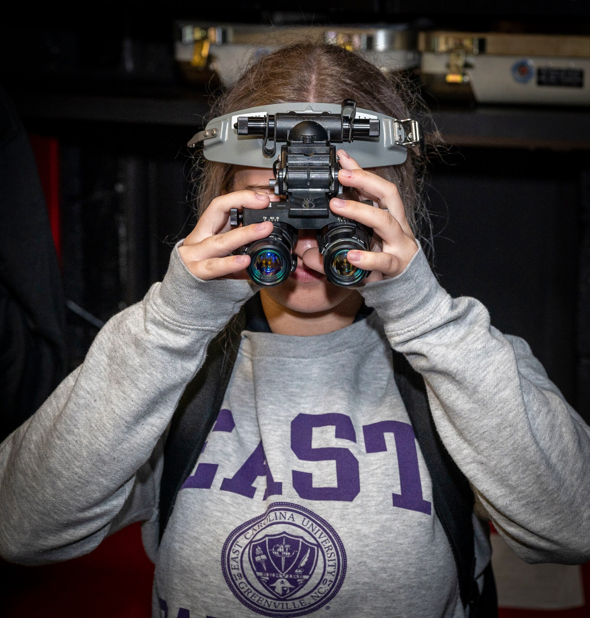 Annie Foery, East Carolina University Air Force ROTC cadet, learns about night vision gear used by the 333rd Fighter Generation Squadron during the Strive 4th: A project Tuskegee and AIM Initiative, at Seymour Johnson Air Force Base, North Carolina, Nov. 4, 2022.