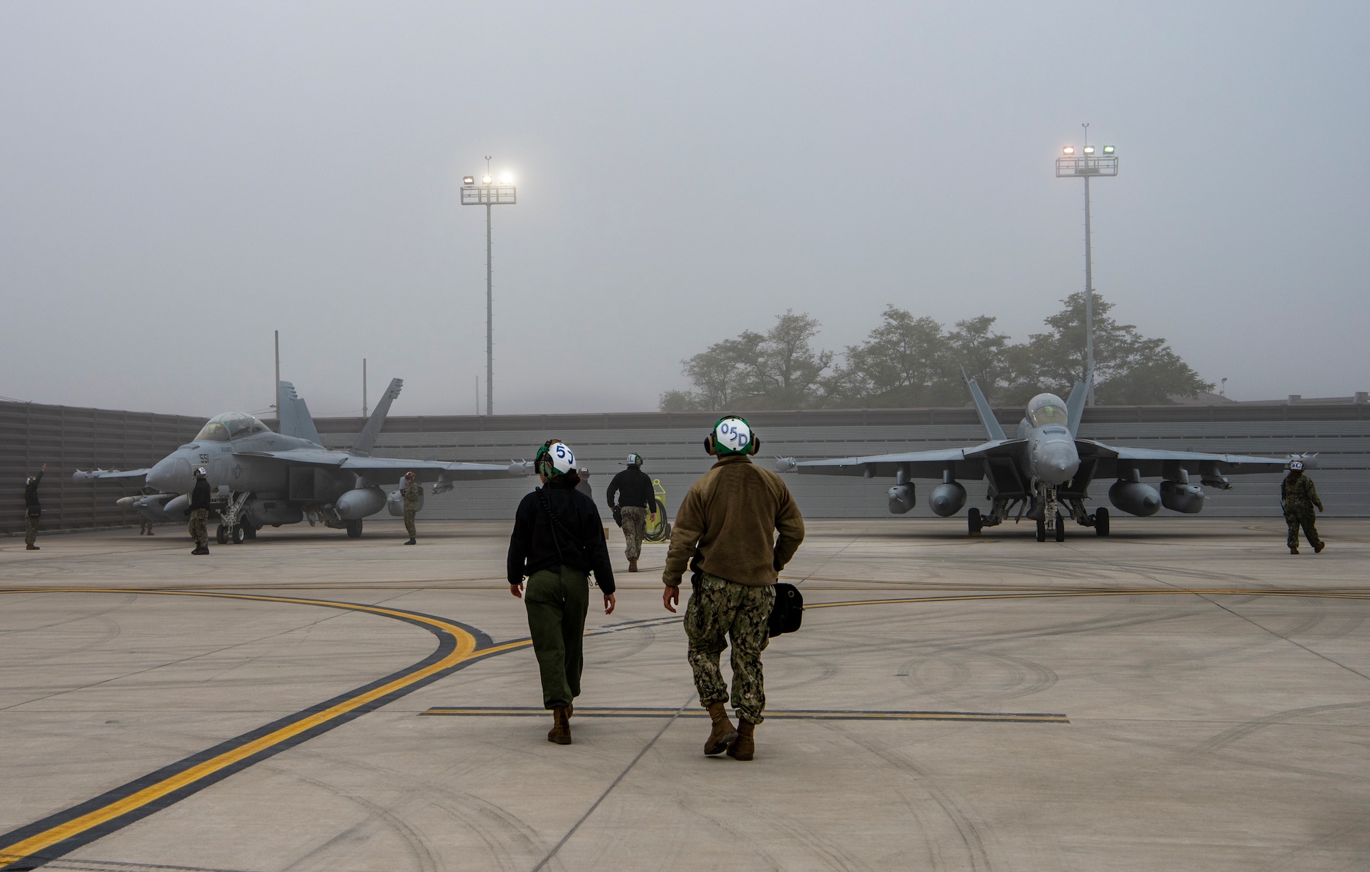 U.S. Navy Airmen assigned to the Electronic Attack Squadron (VAQ) 131 at Naval Air Station Whidbey Island, Washington, perform preflight procedures for EA-18G Growlers during Vigilant Storm 23 at Osan Air Base, Republic of Korea, Nov. 1, 2022.