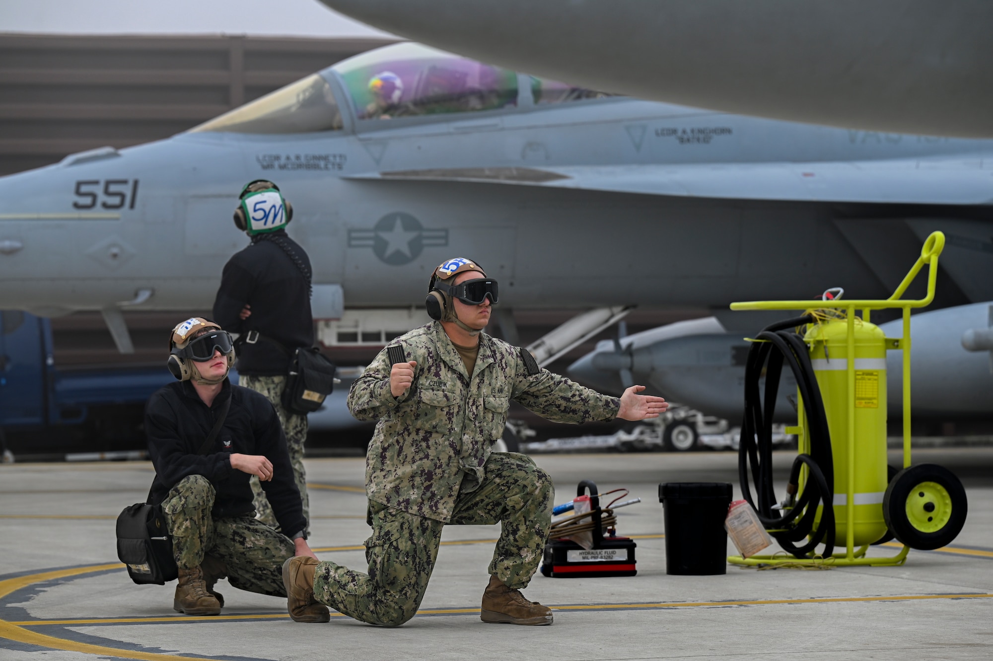 U.S. Navy Airmen assigned to Electronic Attack Squadron 131 at Naval Air Station Whidbey Island, Washington, perform preflight procedures with EA-18G Growlers during Vigilant Storm 23 at Osan Air Base, Republic of Korea, Nov. 1, 2022.