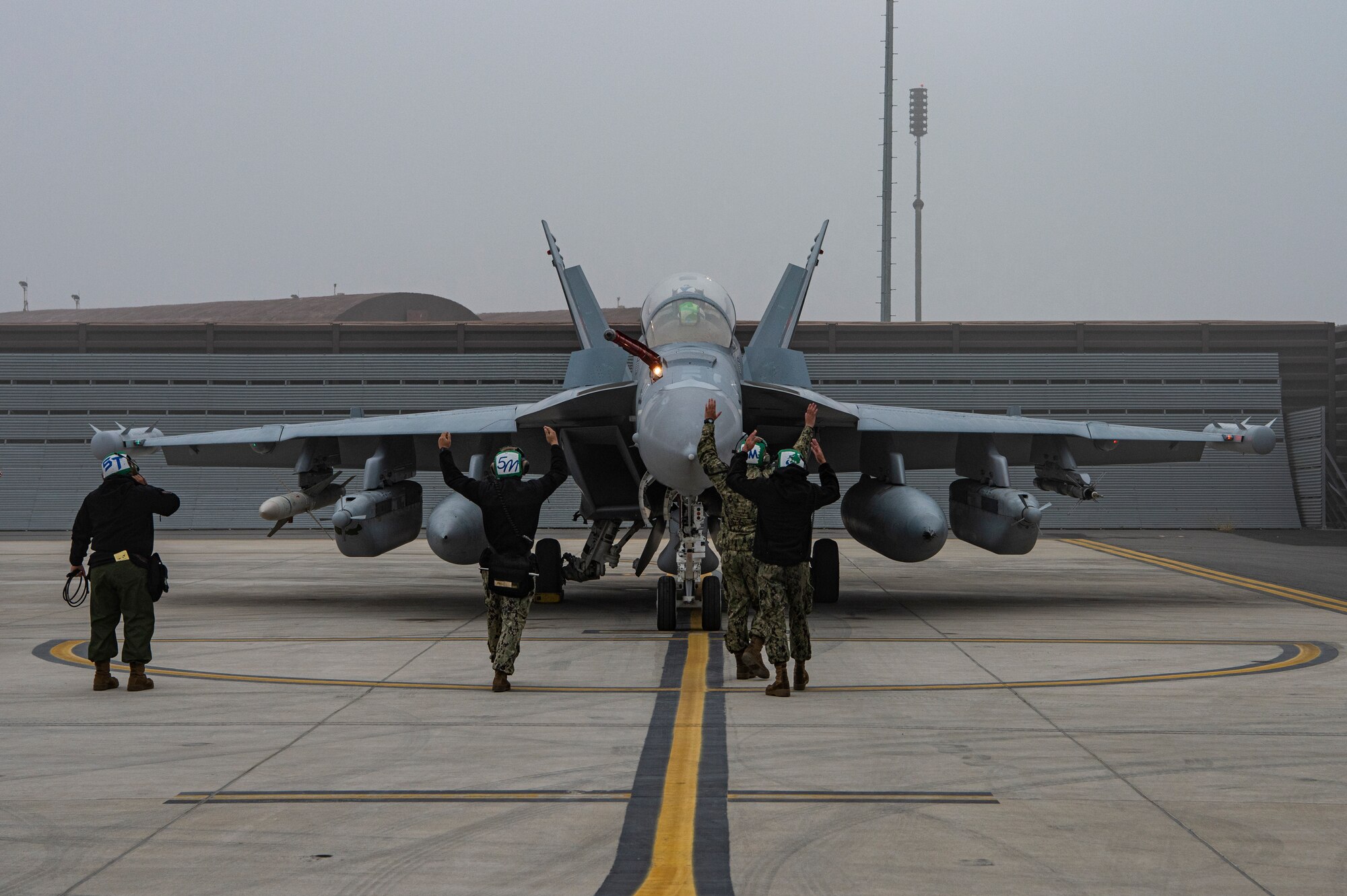 U.S. Navy Airmen assigned to the Electronic Attack Squadron (VAQ) 131 at Naval Air Station Whidbey Island, Washington, perform preflight procedures for EA-18G Growlers during Vigilant Storm 23 at Osan Air Base, Republic of Korea, Nov. 1, 2022.